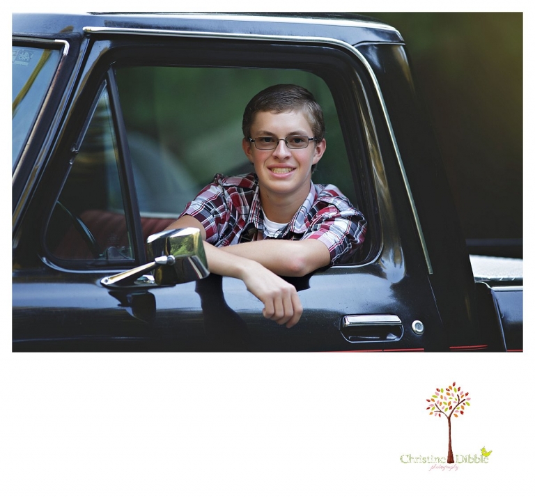 Christine Dibble Photography, Summerville and Sonora senior portrait photographer, takes photos of a boy in the driver's seat of his old black Chevy truck.