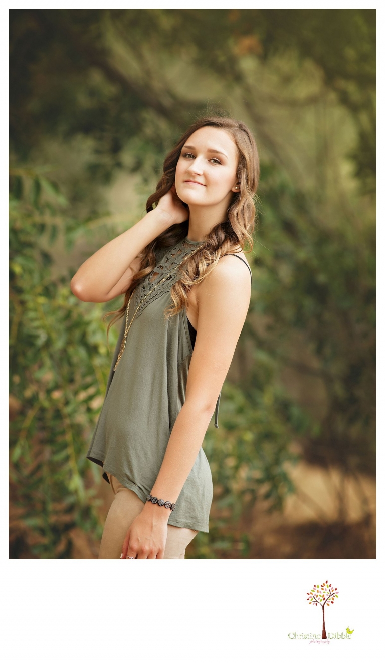 Summerville and Sonora senior portrait photographer Christine Dibble Photography takes photos of a senior girl in a green cut out tank.