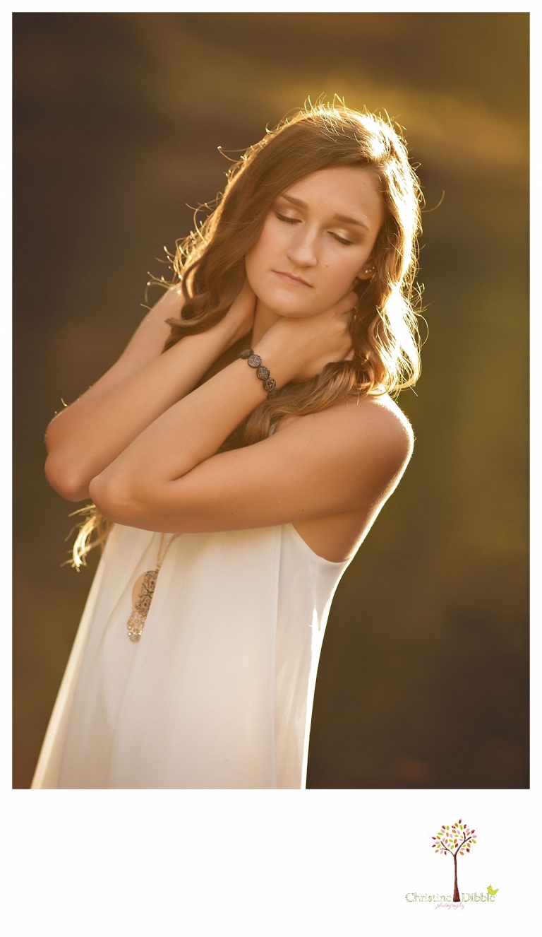 With eyes closed as she stands in the river, a senior girl is photographed by Summerville and Sonora senior portrait photographer Christine Dibble Photography.