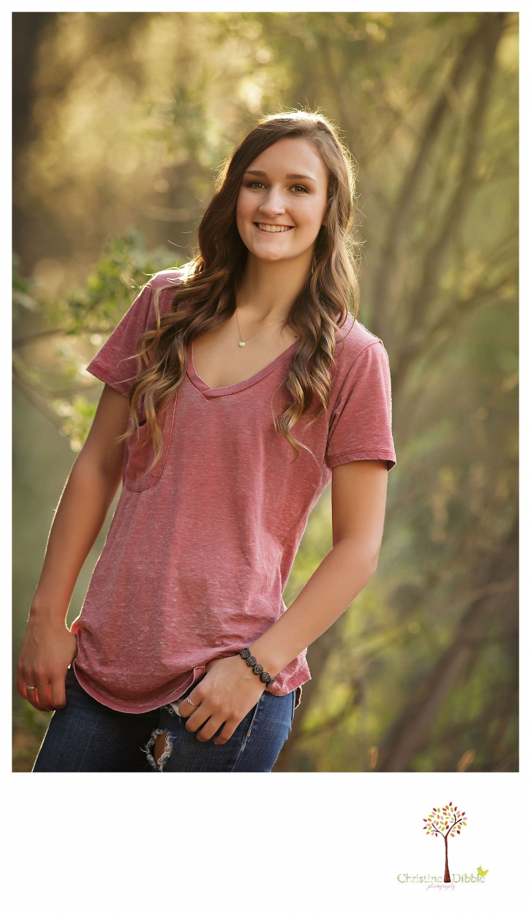 Summerville and Sonora senior portrait photographer Christine Dibble Photography takes photos of a senior girl as she smiles while wearing casual jeans and a t-shirt.