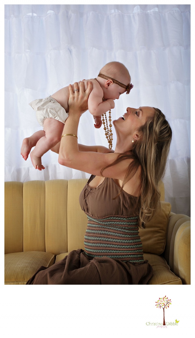 Sonora baby photographer Christine Dibble Photography takes studio portraits for a mommy and me session of a baby girl and her mother as they play.