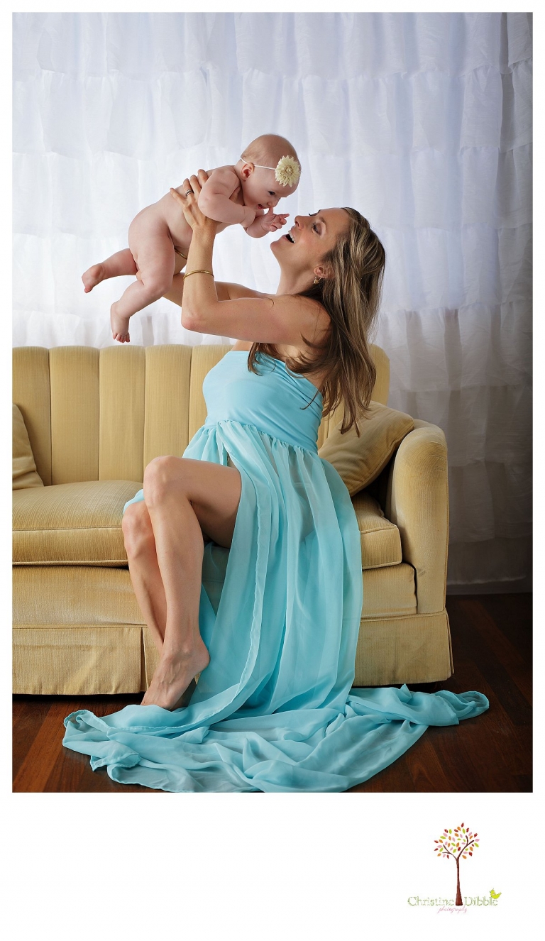 Sonora baby photographer Christine Dibble Photography takes studio portraits for a mommy and me session of a mom playing with her baby girl.