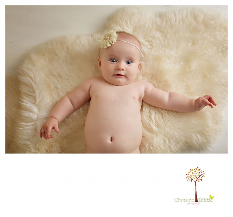 Sonora baby photographer Christine Dibble Photography takes studio portraits of a five month old baby girl on furs.
