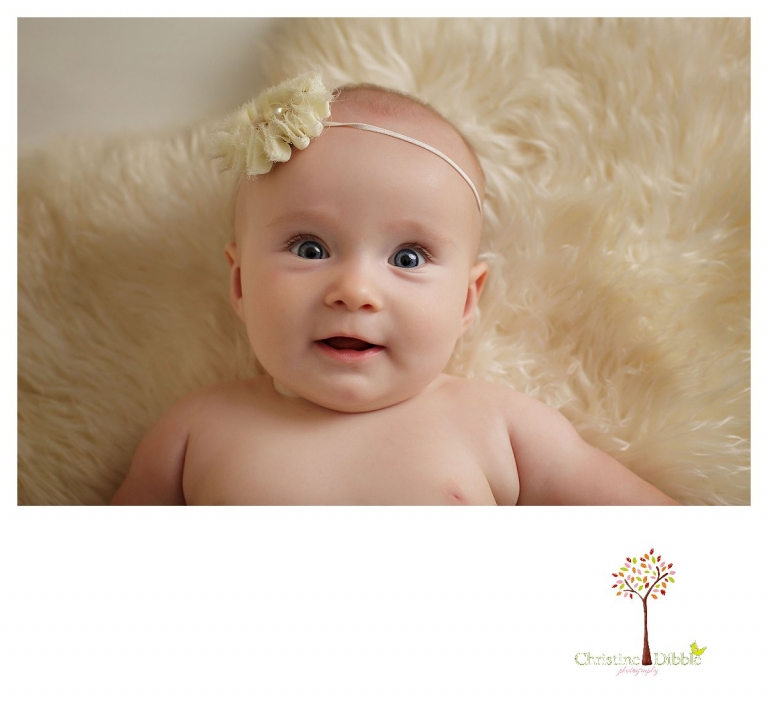 Sonora baby photographer Christine Dibble Photography takes studio portraits for a mommy and me session of a baby girl in a headband.