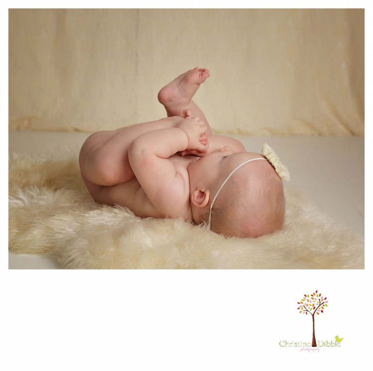 Sonora baby photographer Christine Dibble Photography takes baby photos of a baby girl chewing her bare feet.