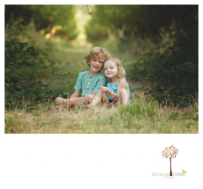 Sonora family photographer Christine Dibble Photography takes portraits of siblings sitting in the Indigeny apple orchard.