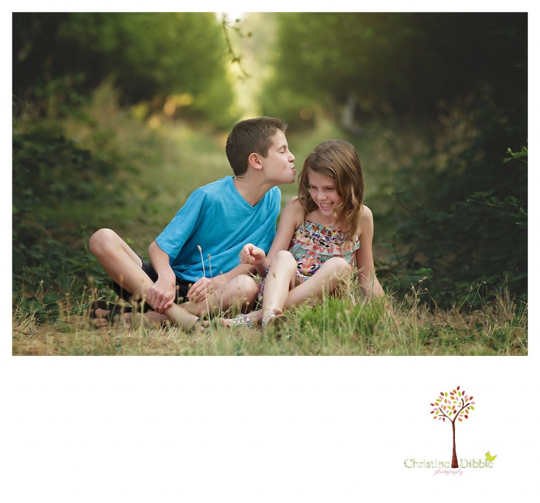 Sonora family photographer Christine Dibble Photography takes a photo of a brother trying to kiss his sister.