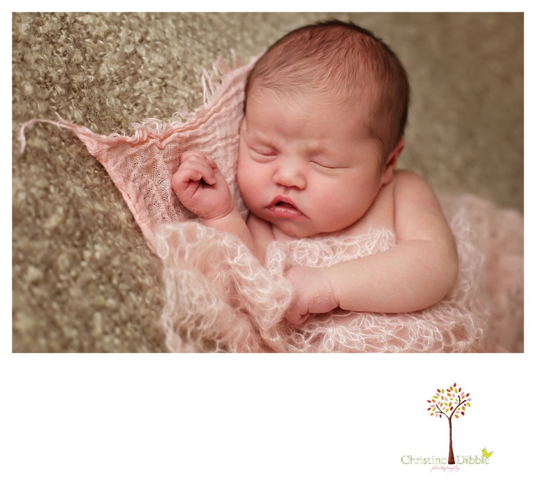 Newborn photography by Sonora photographer Christine Dibble Photography includes studio sessions with posed images of a baby girl sleeping on layers on a blanket.
