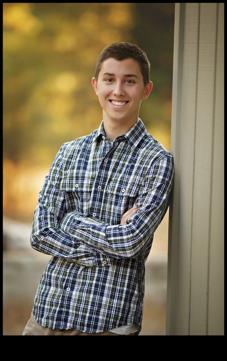 During a senior portrait session with Christine Dibble Photography of Sonora, a boy smiles for a portrait.