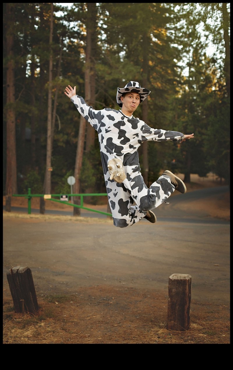A Summerville High senior boy dressed in a cow costume does a High School Musical style jump during a senior portrait session with Christine Dibble Photography of Sonora.