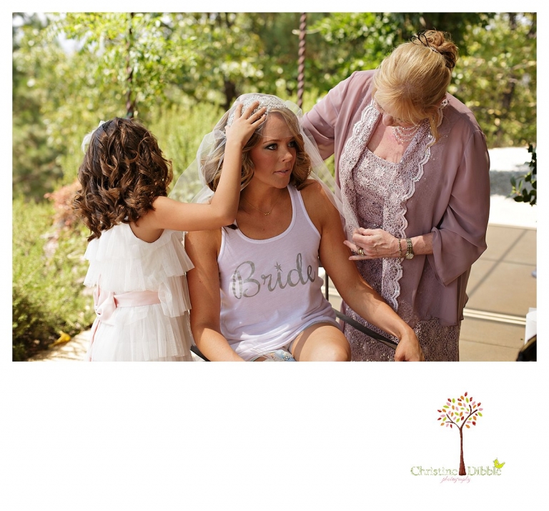 Sonora wedding photographer Christine Dibble Photographer captures a Venticello wedding in Murphys as the bride's mother and daughter adjust her veil.