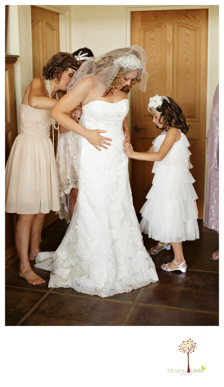 Sonora wedding photographer Christine Dibble Photographer captures a Venticello wedding in Murphys as the bride puts her dress on.
