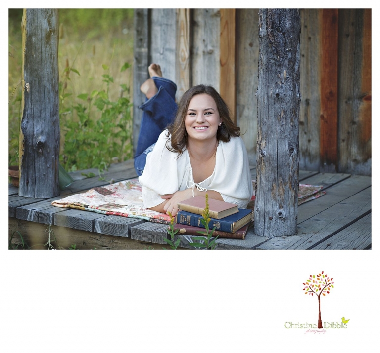 Senior portraits in Sonora taken of a Summerville Class of 2016 senior by Christine Dibble Photography captures a girl reading on a weathered wooden porch.