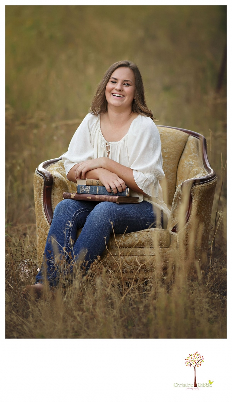 Senior portraits in Sonora taken of a Summerville Class of 2016 senior by Christine Dibble Photography includes props such as a vintage brocade chair in a field.