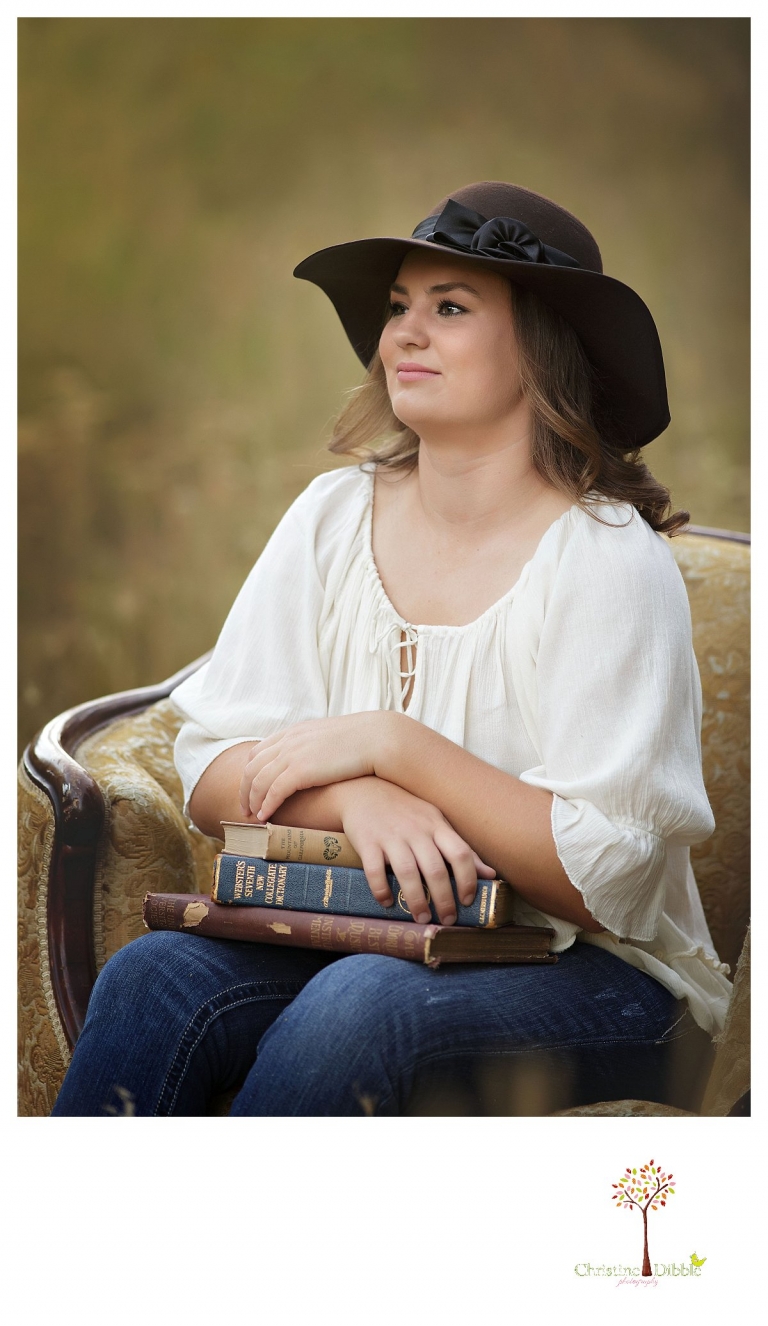 Senior portraits in Sonora taken of a Summerville Class of 2016 senior by Christine Dibble Photography includes a girl in her floppy felt hat in a chair in a field.