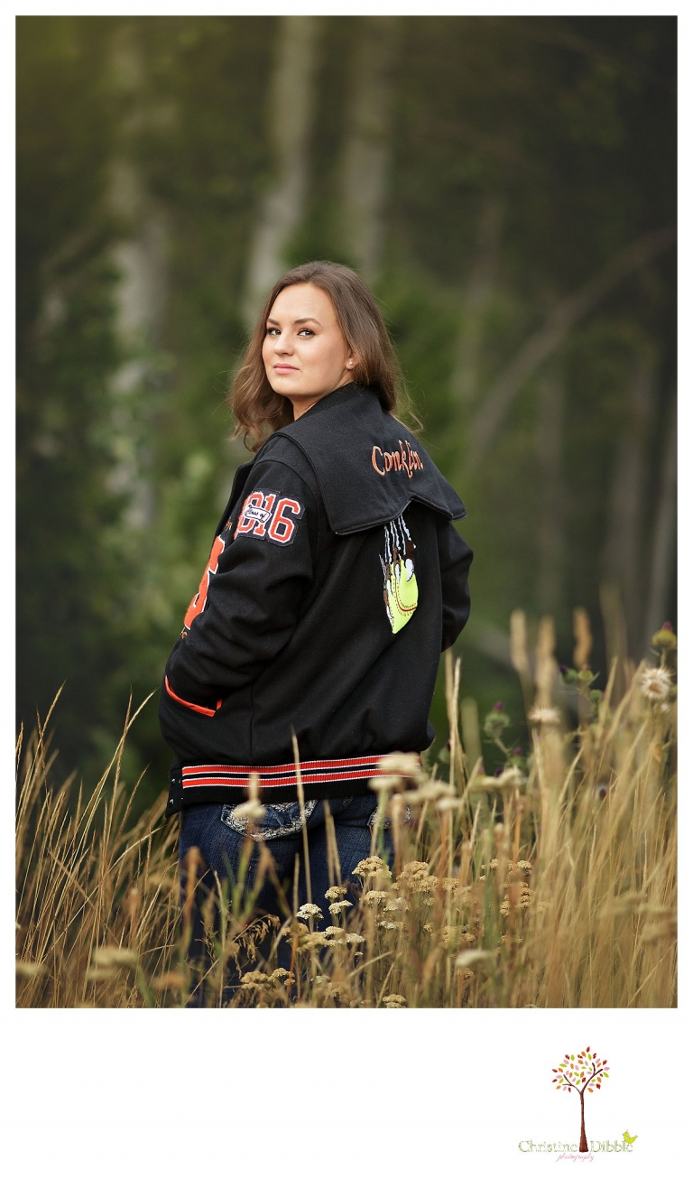 Summerville and Sonora senior portrait photographer Christine Dibble Photoraphy takes portraits showing a girl in her custom Summerville varsity letterman jacket.