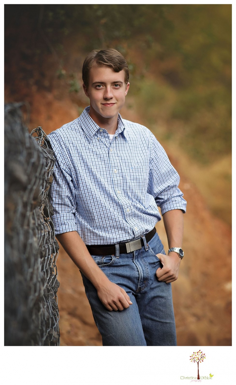 Summerville High senior portrait photographer Christine Dibble Photography takes outdoor senior portraits outside on the Dragoon Gulch Trail in Sonora of a boy in a plaid dress shirt and jeans.