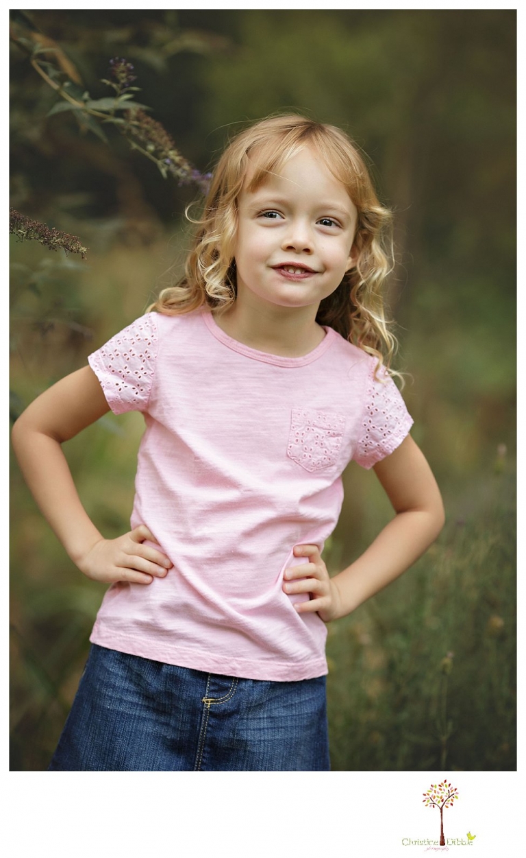 Sonora family photographer Christine Dibble Photography takes photos of big sister at a family portrait session at Twain Harte Tree Farm.