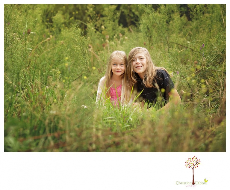 Sonora family portrait photographer Christine Dibble Photography takes family photos on a rainy day at Indigeny Reserve as a family plays in the orchards and corn field.