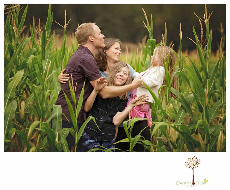 Sonora family portrait photographer Christine Dibble Photography takes family photos on a rainy day at Indigeny Reserve as a family plays in the orchards and corn field.