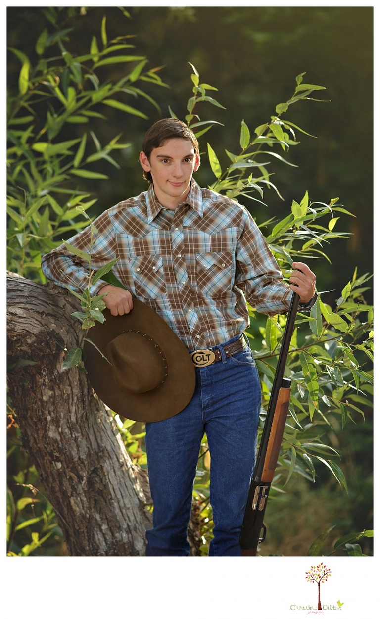 Summerville High and Sonora senior portrait photographer Christine Dibble Photography takes outdoor senior portraits of a cowboy with his trap shooting gun.