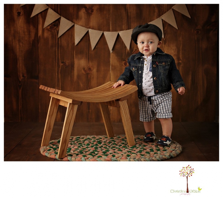 Sonora baby and child photographer Christine Dibble Photography takes first year portraits in her studio of a little boy with a red wagon and vintage accessories.