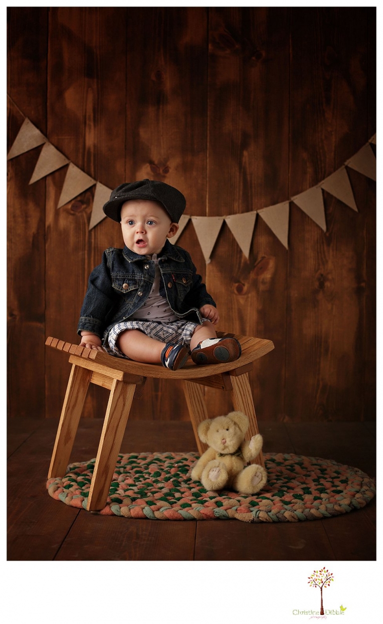 Sonora baby and child photographer Christine Dibble Photography takes first year portraits in her studio of a little boy with a red wagon and vintage accessories.