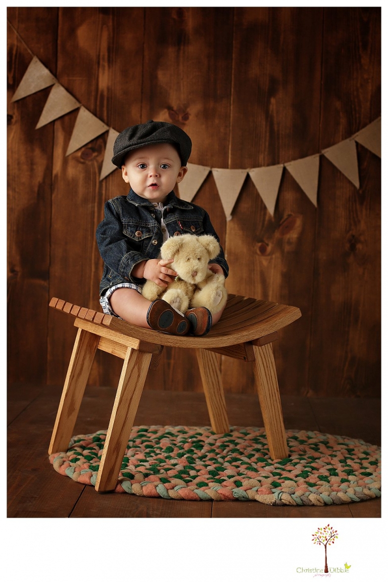 Sonora baby and child photographer Christine Dibble Photography takes first year portraits in her studio of a little boy with a red wagon and vintage accessories.