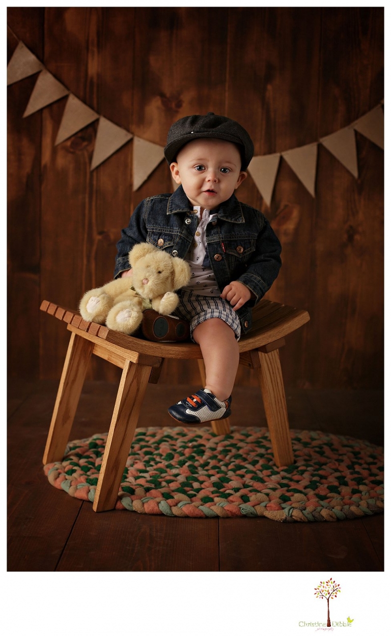 Sonora baby and child photographer Christine Dibble Photography takes first year portraits in her studio of a little boy with a red wagon and vintage accessories.