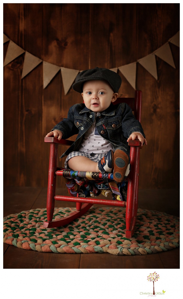 Sonora baby and child photographer Christine Dibble Photography takes first year portraits in her studio of a little boy with a red wagon and vintage accessories.