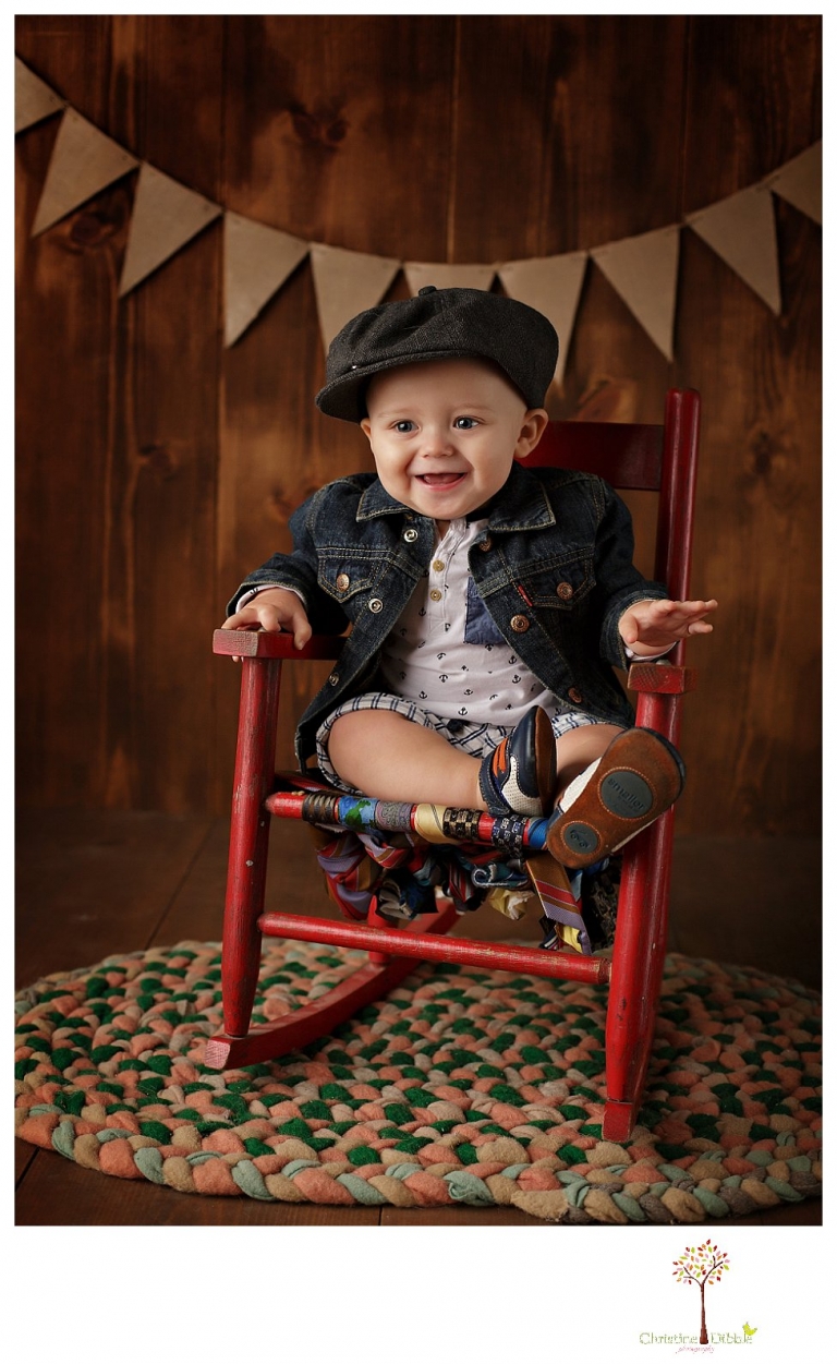 Sonora baby and child photographer Christine Dibble Photography takes first year portraits in her studio of a little boy with a red wagon and vintage accessories.
