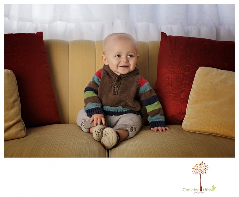 Sonora baby and child photographer Christine Dibble Photography takes first year portraits in her studio of a little boy with a red wagon and vintage accessories.