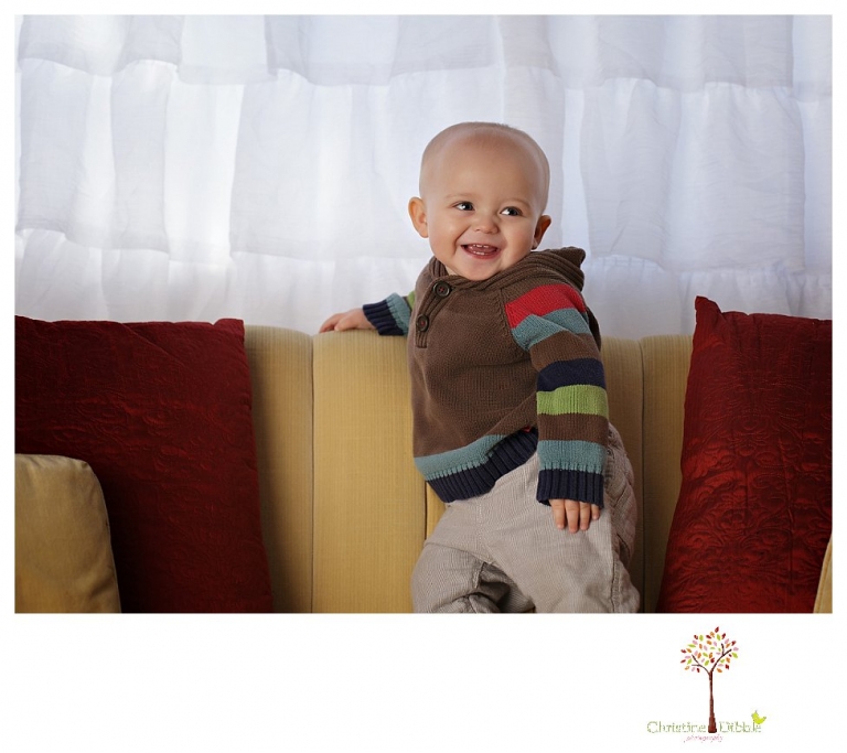Sonora baby and child photographer Christine Dibble Photography takes first year portraits in her studio of a little boy with a red wagon and vintage accessories.