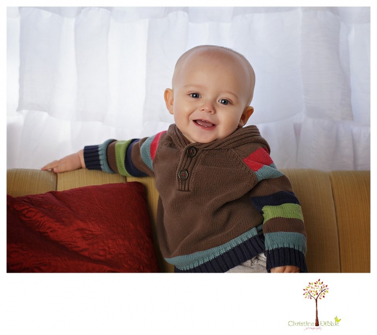 Sonora baby and child photographer Christine Dibble Photography takes first year portraits in her studio of a little boy with a red wagon and vintage accessories.