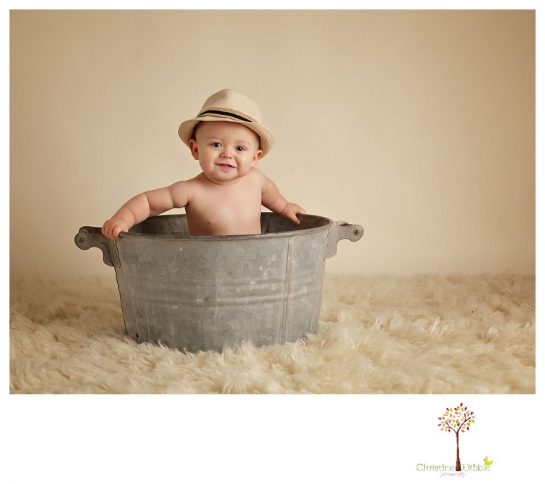 Sonora baby and child photographer Christine Dibble Photography takes first year portraits in her studio of a little boy with a red wagon and vintage accessories.