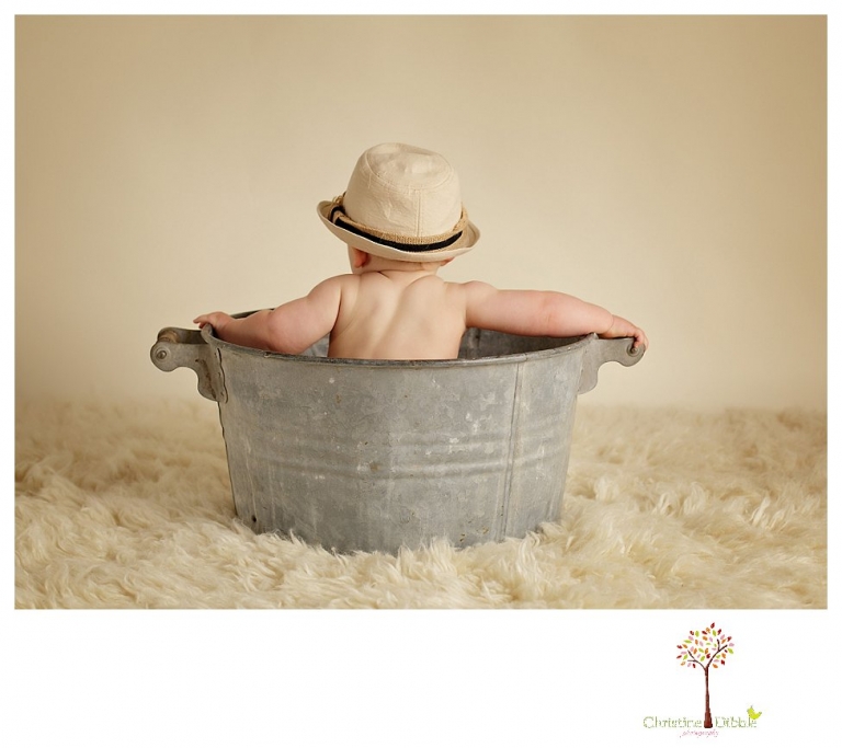 Sonora baby and child photographer Christine Dibble Photography takes first year portraits in her studio of a little boy with a red wagon and vintage accessories.