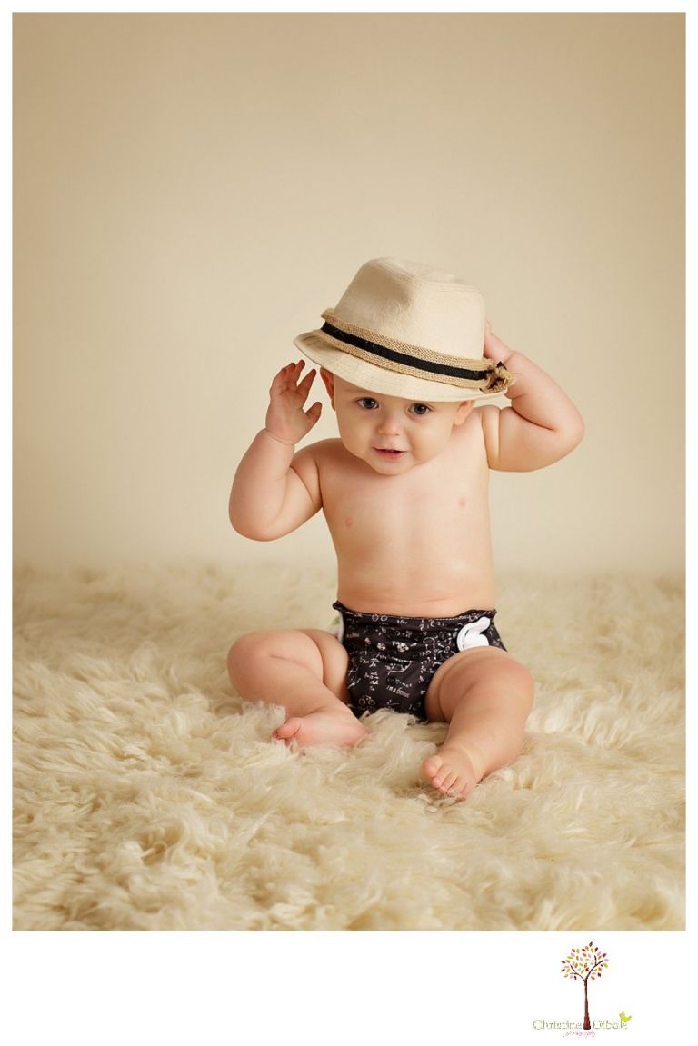 Sonora baby and child photographer Christine Dibble Photography takes first year portraits in her studio of a little boy with a red wagon and vintage accessories.