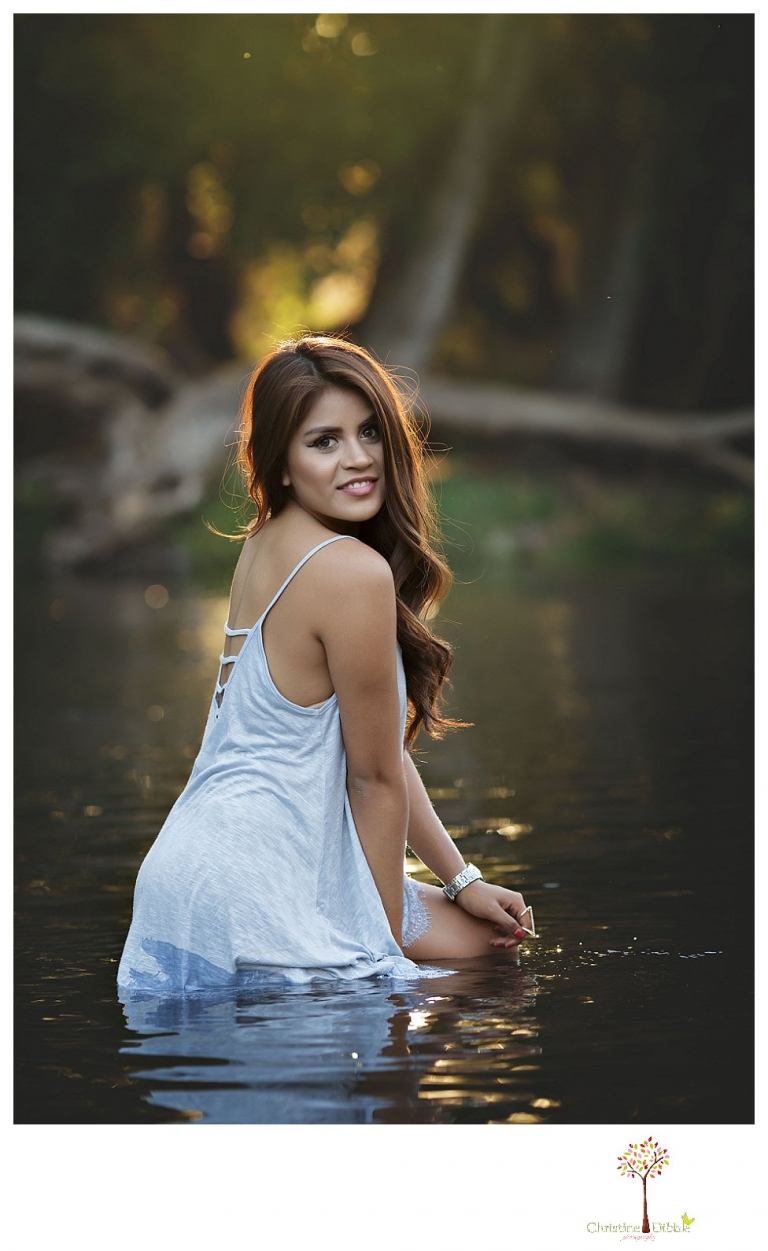 Sonora senior portrait photographer Christine Dibble Photography takes senior portraits of a beautiful Gustine High School Class of 2016 senior at Knights Ferry, sitting in the river in her sundress.