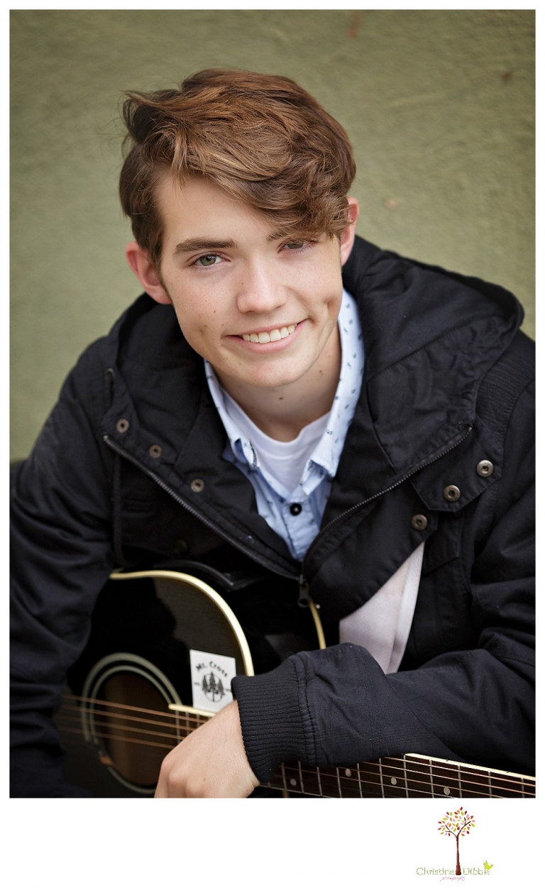 Sonora High senior portrait photographer Christine Dibble Photography photographs a senior boy in downtown Sonora with his guitar and in his Golden Regiment Band drum major uniform.