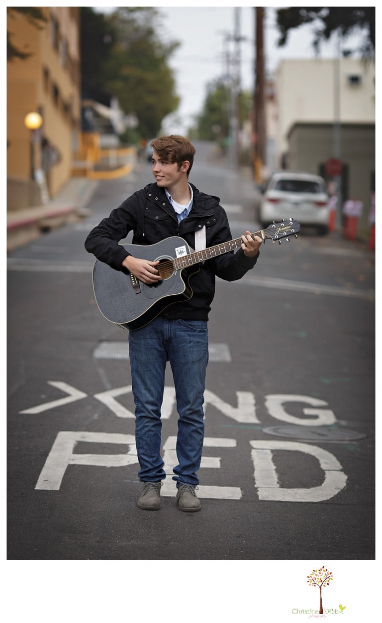 Sonora High senior portrait photographer Christine Dibble Photography photographs a senior boy in downtown Sonora with his guitar and in his Golden Regiment Band drum major uniform.
