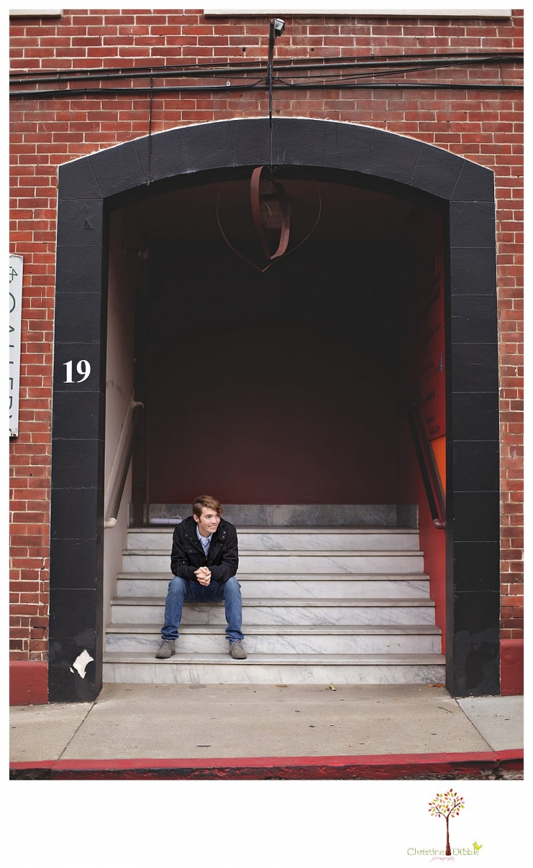 Sonora High senior portrait photographer Christine Dibble Photography photographs a senior boy in downtown Sonora with his guitar and in his Golden Regiment Band drum major uniform.