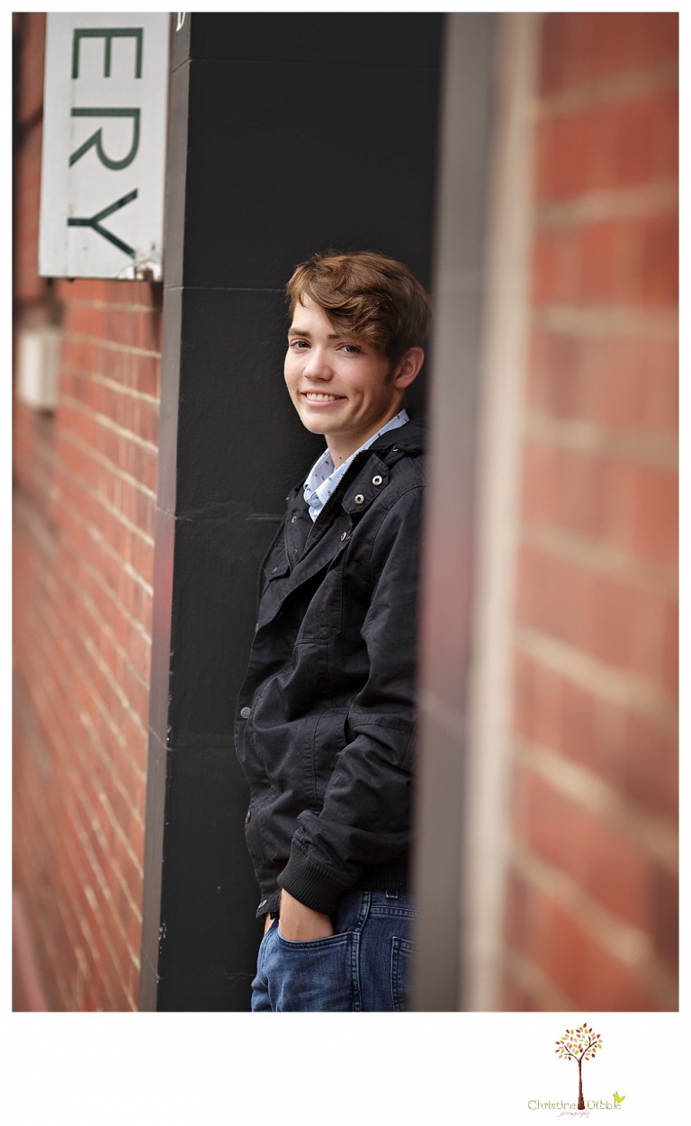 Sonora High senior portrait photographer Christine Dibble Photography photographs a senior boy in downtown Sonora with his guitar and in his Golden Regiment Band drum major uniform.