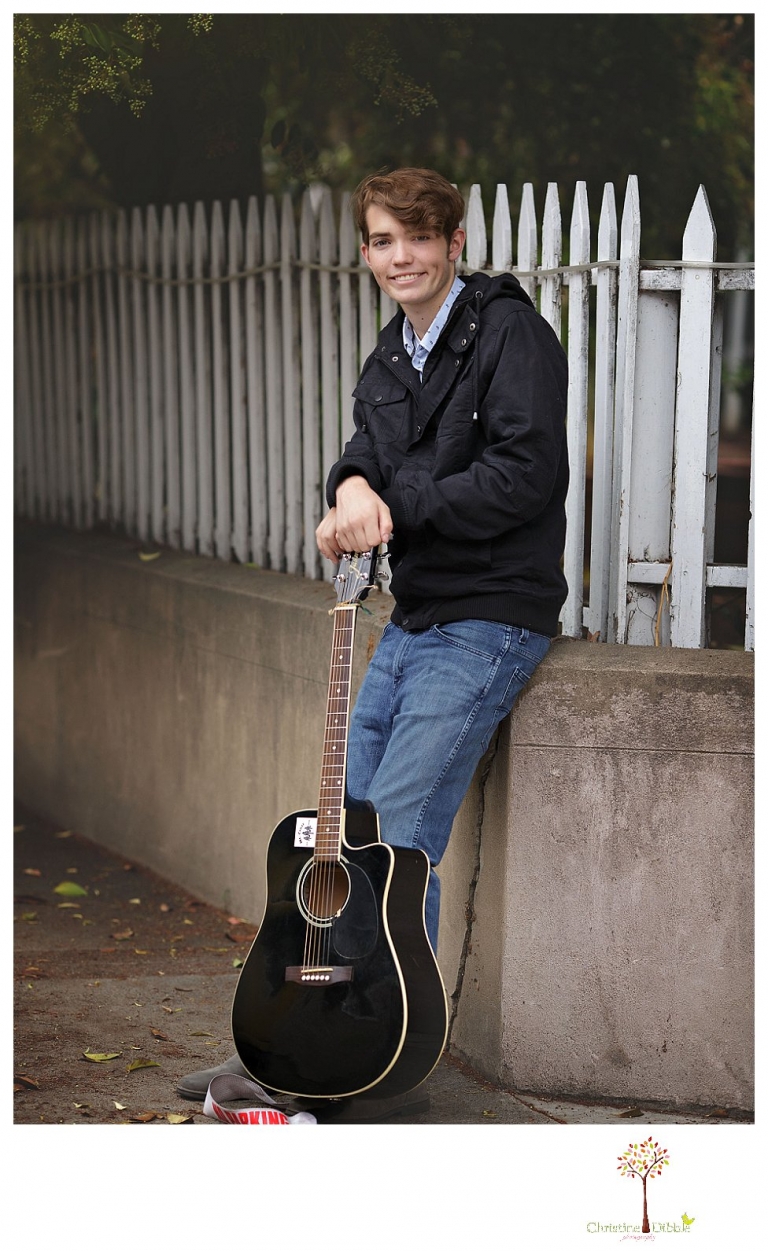 Sonora High senior portrait photographer Christine Dibble Photography photographs a senior boy in downtown Sonora with his guitar and in his Golden Regiment Band drum major uniform.