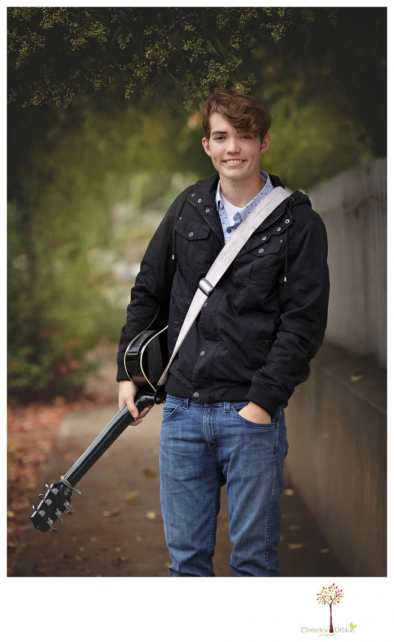 Sonora High senior portrait photographer Christine Dibble Photography photographs a senior boy in downtown Sonora with his guitar and in his Golden Regiment Band drum major uniform.