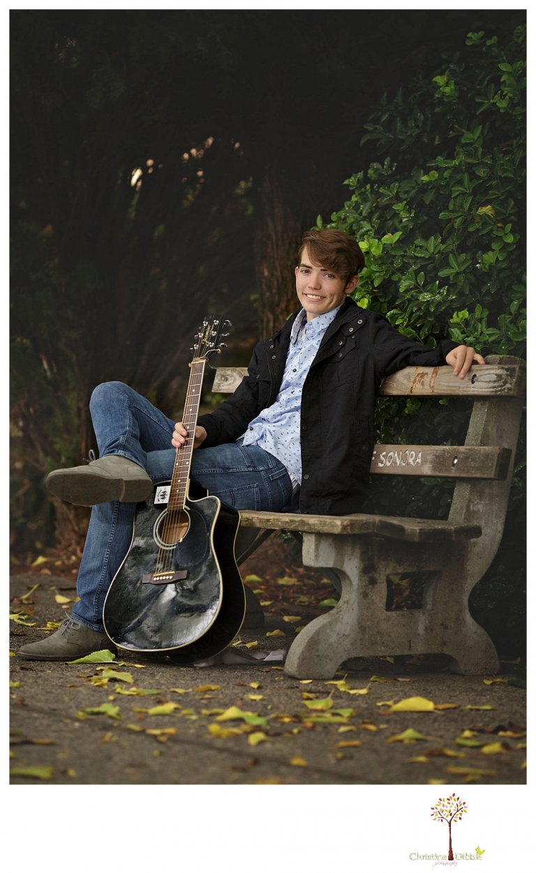 Sonora High senior portrait photographer Christine Dibble Photography photographs a senior boy in downtown Sonora with his guitar and in his Golden Regiment Band drum major uniform.