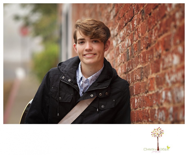 Sonora High senior portrait photographer Christine Dibble Photography photographs a senior boy in downtown Sonora with his guitar and in his Golden Regiment Band drum major uniform.