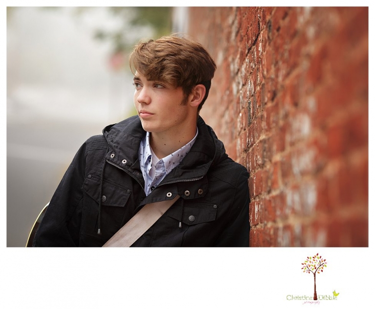 Sonora High senior portrait photographer Christine Dibble Photography photographs a senior boy in downtown Sonora with his guitar and in his Golden Regiment Band drum major uniform.
