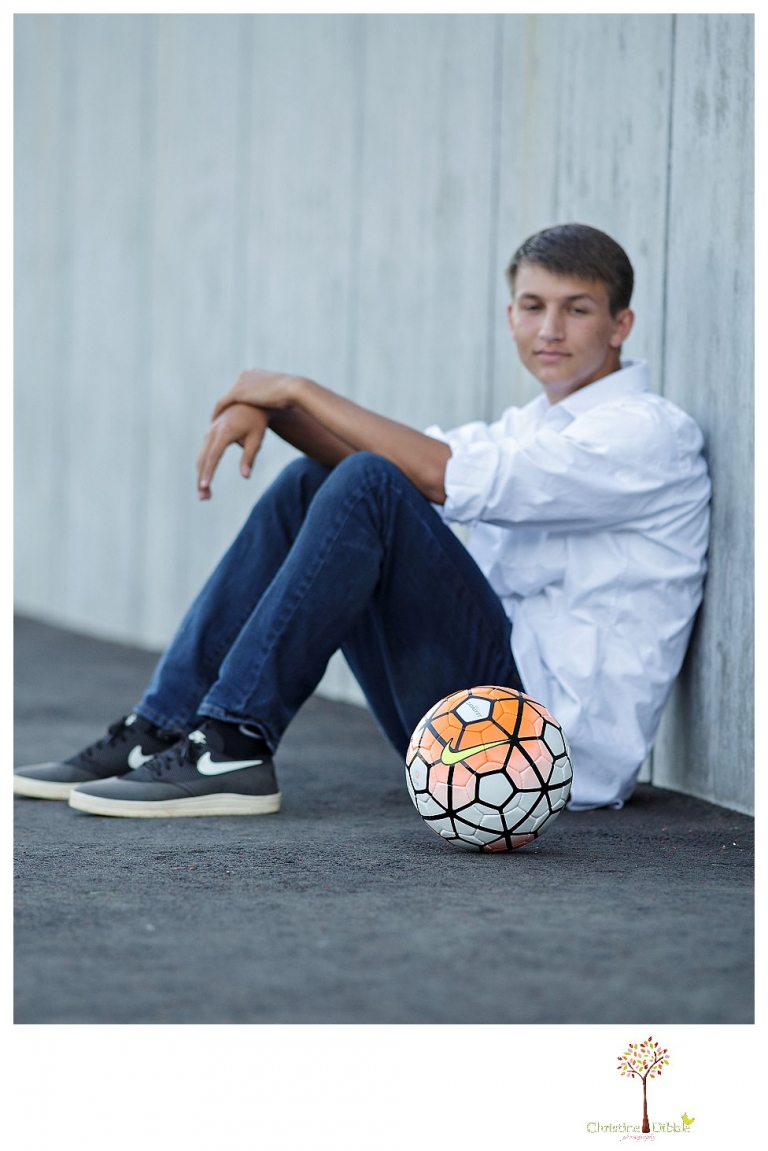 Summerville senior portrait photographer, Christine Dibble Photography of Sonora takes senior portraits of a senior boy in casual and dress clothes and in his soccer uniform on the Summerville soccer field.