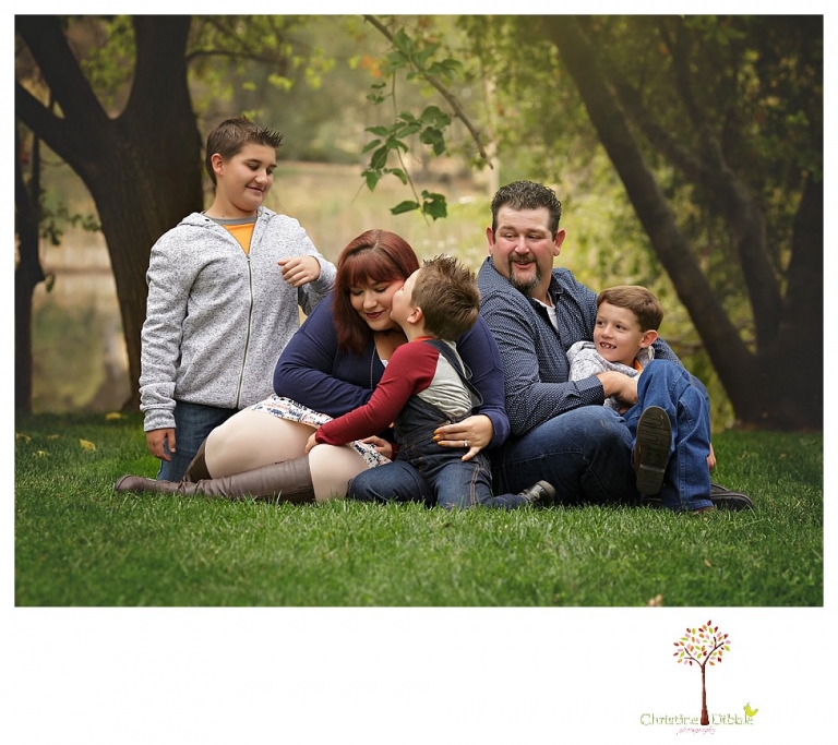 Sonora family photographer Christine Dibble Photography takes family portraits in Angels Camp of a family with three boys on private property with olive trees and a pond.