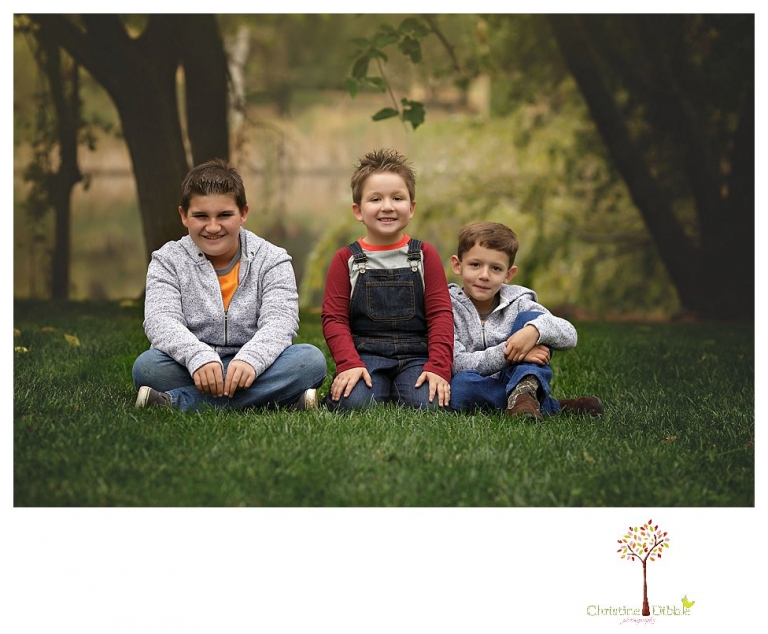 Sonora family photographer Christine Dibble Photography takes family portraits in Angels Camp of a family with three boys on private property with olive trees and a pond.